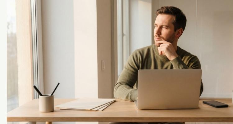 Man zit achter laptop en denkt na over Cruks opzeggen en het aanpassen van zijn gokstop registratie
